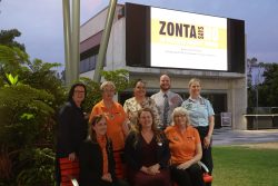 Members of Zonta Ipswich and Ipswich City Councillors sitting on the red bench in Tulmur Place
